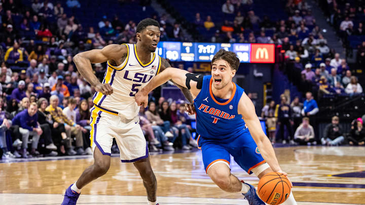 Feb 22, 2025; Baton Rouge, Louisiana, USA;  Florida Gators guard Urban Klavzar (7) dribbles against LSU Tigers guard Cam Carter (5) during the second half at Pete Maravich Assembly Center. Mandatory Credit: Stephen Lew-Imagn Images