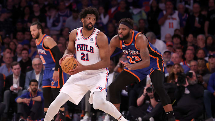 Apr 30, 2024; New York, New York, USA; Philadelphia 76ers center Joel Embiid (21) handles the ball against New York Knicks center Mitchell Robinson (23) during overtime in game 5 of the first round of the 2024 NBA playoffs at Madison Square Garden. Mandatory Credit: Brad Penner-Imagn Images