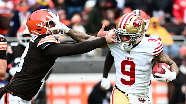Nov 30, 2025; Cleveland, Ohio, USA; San Francisco 49ers wide receiver Skyy Moore (9) stiff arms Cleveland Browns punter Corey Bojorquez (13) during the first quarter at Huntington Bank Field. Mandatory Credit: Ken Blaze-Imagn Images