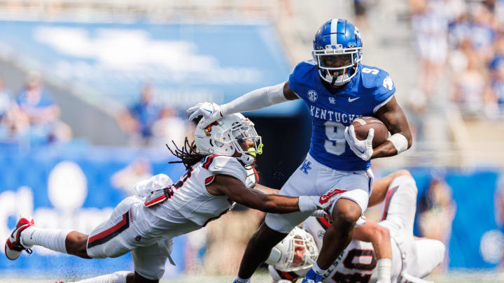 Sep 2, 2023; Lexington, Kentucky, USA; Kentucky Wildcats wide receiver Tayvion Robinson (9) carries the ball against Ball State Cardinals defensive back Thailand Baldwin (12) during the fourth quarter at Kroger Field. Mandatory Credit: Jordan Prather-USA TODAY Sports