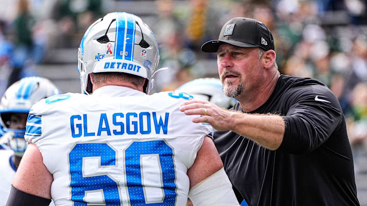 Detroit Lions head coach Dan Campbell shakes hands with guard Graham Glasgow (60) at warm up at Lambeau Field in Green Bay, Wis., on Sunday, September 7, 2025.