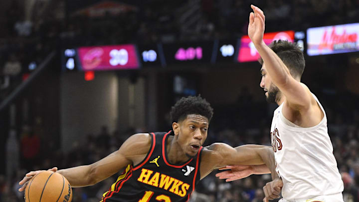 Nov 27, 2024; Cleveland, Ohio, USA; Atlanta Hawks forward De'Andre Hunter (12) drives as Cleveland Cavaliers guard Ty Jerome (2) defends in the first quarter at Rocket Mortgage FieldHouse. Mandatory Credit: David Richard-Imagn Images