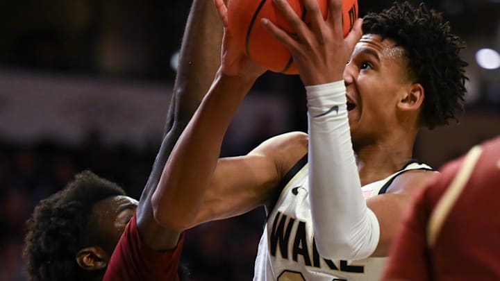 Feb 28, 2023; Winston-Salem, North Carolina, USA; Wake Forest Demon Deacons forward Bobi Klintman (34) shoots underneath against Boston College Eagles guard Prince Aligbe (10) during the first half at Lawrence Joel Veterans Memorial Coliseum. Mandatory Credit: William Howard-Imagn Images