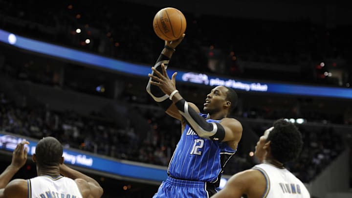 Dwight Howard shoots while Nick Young (right) watches in 2010.