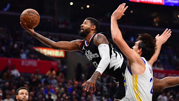 Dec 2, 2023; Los Angeles, California, USA; Los Angeles Clippers forward Paul George (13) moves to the basket against Golden State Warriors forward Dario Saric (20) during the second half at Crypto.com Arena. Mandatory Credit: Gary A. Vasquez-Imagn Images