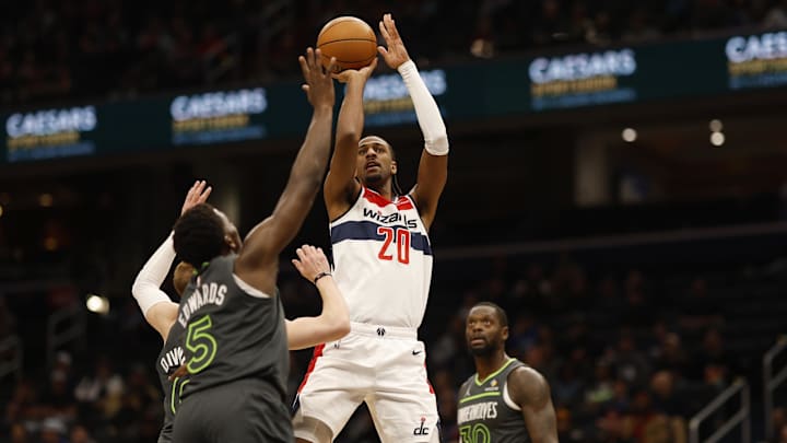 Jan 13, 2025; Washington, District of Columbia, USA; Washington Wizards forward Alexandre Sarr (20) shoots the ball as Minnesota Timberwolves guard Anthony Edwards (5) defends in the second quarter at Capital One Arena. Mandatory Credit: Geoff Burke-Imagn Images