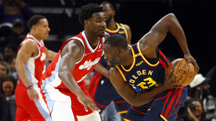 Dec 19, 2024; Memphis, Tennessee, USA; Golden State Warriors forward Draymond Green (23) handles the ball as Memphis Grizzlies forward Jaren Jackson Jr. (13) defends during the first quarter at FedExForum. Mandatory Credit: Petre Thomas-Imagn Images