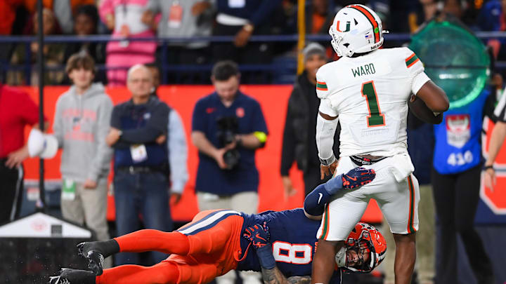 Nov 30, 2024; Syracuse, New York, USA; Syracuse Orange defensive back Justin Barron (8) attempts to sack Miami Hurricanes quarterback Cam Ward (1) during the second half at the JMA Wireless Dome. Mandatory Credit: Rich Barnes-Imagn Images