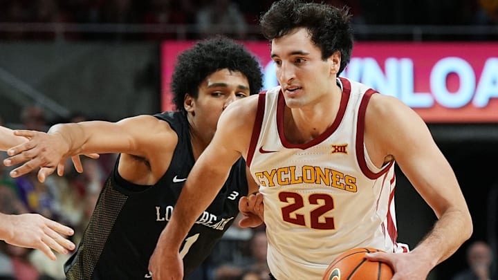 Iowa State Cyclones forward Milan Momcilovic (22) drives with the ball around Long Beach State guard Gavin Sykes (11) during the first half in the NCAA men’s basketball on Dec. 21, 2025, at Hilton Coliseum in Ames, Iowa.