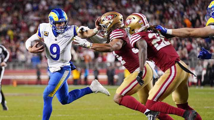 Dec 12, 2024; Santa Clara, California, USA; Los Angeles Rams quarterback Matthew Stafford (9) runs with the ball as San Francisco 49ers linebacker Fred Warner (54) defends in the fourth quarter at Levi's Stadium. Mandatory Credit: Cary Edmondson-Imagn Images