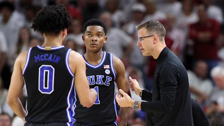 Nov 29, 2023; Fayetteville, Arkansas, USA; Duke basketball head coach Jon Scheyer talks to guards Jared McCain and Caleb Foster