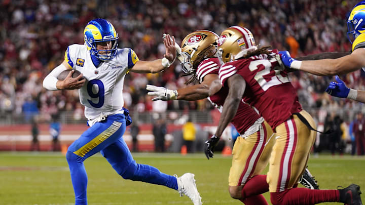 Dec 12, 2024; Santa Clara, California, USA; Los Angeles Rams quarterback Matthew Stafford (9) runs with the ball as San Francisco 49ers linebacker Fred Warner (54) defends in the fourth quarter at Levi's Stadium. Mandatory Credit: Cary Edmondson-Imagn Images