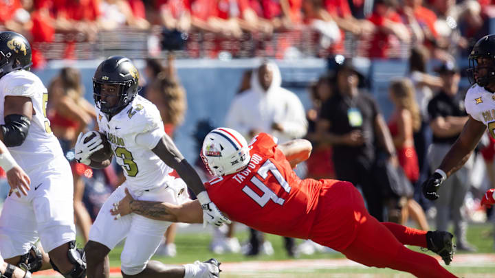 Oct 19, 2024; Tucson, Arizona, USA; Colorado Buffalos running back Isaiah Augustave (23) against Arizona Wildcats defensive lineman Stanley Ta'ufo'ou (47) at Arizona Stadium. Mandatory Credit: Mark J. Rebilas-Imagn Images