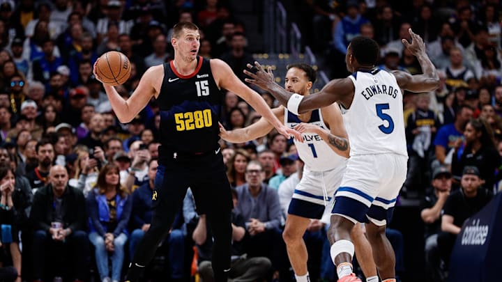  Denver Nuggets center Nikola Jokic (15) controls the ball as Minnesota Timberwolves forward Kyle Anderson (1) and guard Anthony Edwards (5) defend in the first quarter during game two of the second round for the 2024 NBA playoffs at Ball Arena. Mandatory Credit: Isaiah J. Downing-Imagn Images