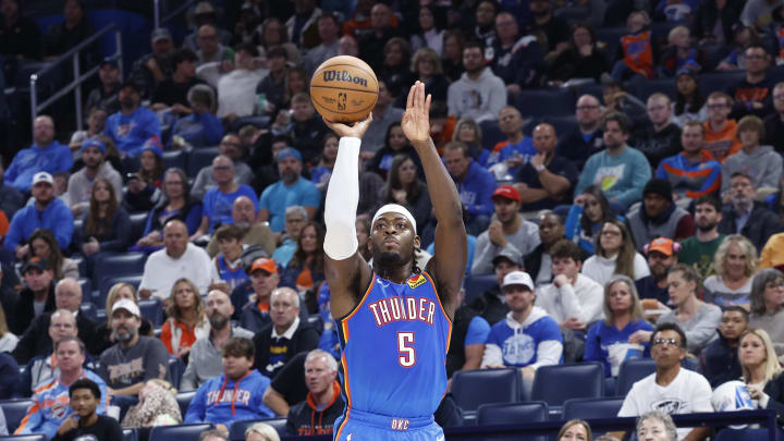 Oct 29, 2023; Oklahoma City, Oklahoma, USA; Oklahoma City Thunder guard Luguentz Dort (5) shoots a three point basket against the Denver Nuggets during the second half at Paycom Center. Mandatory Credit: Alonzo Adams-USA TODAY Sports Oct 29, 2023; Oklahoma City, Oklahoma, USA; Oklahoma City Thunder guard Luguentz Dort (5) shoots a three point basket against the Denver Nuggets during the second half at Paycom Center. Mandatory Credit: Alonzo Adams-USA TODAY Sports
