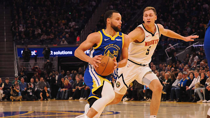 Mar 17, 2025; San Francisco, California, USA; Golden State Warriors guard Stephen Curry (30) drives in against Denver Nuggets forward Hunter Tyson (5) during the first quarter at Chase Center. Mandatory Credit: Kelley L Cox-Imagn Images