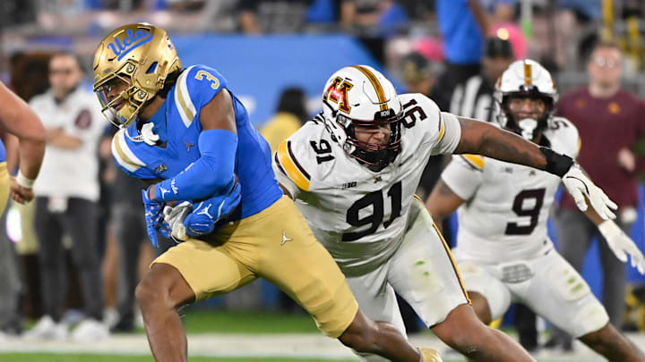 Oct 12, 2024; Pasadena, California, USA; UCLA Bruins wide receiver Kwazi Gilmer (3) runs past Minnesota Golden Gophers defensive lineman Deven Eastern (91) during the second quarter at Rose Bowl. Mandatory Credit: Robert Hanashiro-Imagn Images Oct 12, 2024; Pasadena, California, USA; UCLA Bruins wide receiver Kwazi Gilmer (3) runs past Minnesota Golden Gophers defensive lineman Deven Eastern (91) during the second quarter at Rose Bowl. Mandatory Credit: Robert Hanashiro-Imagn Images