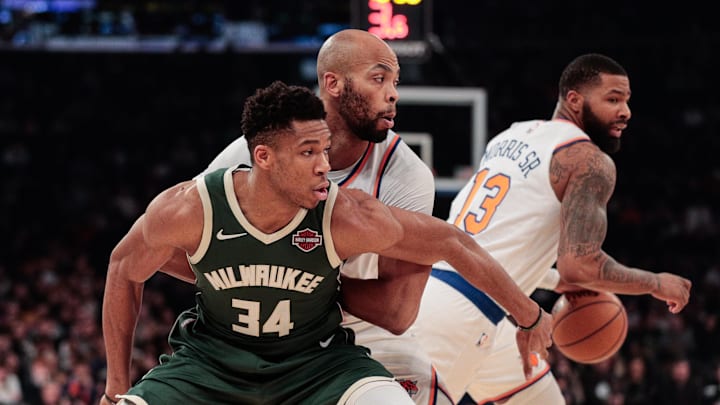 Dec 21, 2019; New York, New York, USA; Milwaukee Bucks forward Giannis Antetokounmpo (34) fights for position against New York Knicks forward Taj Gibson (67) as Marcus Morris Sr. (13) dribbles the ball during the first quarter at Madison Square Garden. Mandatory Credit: Vincent Carchietta-Imagn Images