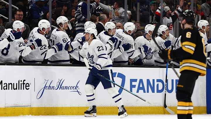 Mar 24, 2026; Boston, Massachusetts, USA; As Boston Bruins defenseman Mason Lohrei (6) heads for his bench, Toronto Maple Leafs left wing Matthew Knies (23) is congratulated at the bench after scoring a shorthanded goal during the second period at TD Garden. Mandatory Credit: Winslow Townson-Imagn Images