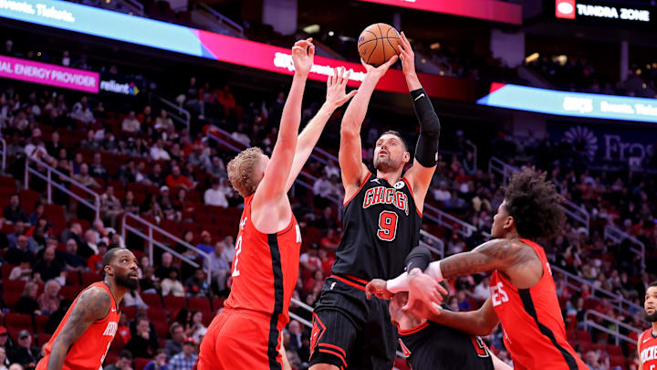; Chicago Bulls center Nikola Vucevic (9) shoots against Houston Rockets center Jock Landale (2) during the first quarter at Toyota Center. Mandatory Credit: Erik Williams-Imagn Images
