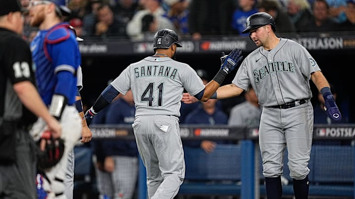 Seattle Mariners designated hitter Carlos Santana (41) celebrates his three run home run with catcher Cal Raleigh (29) in the sixth inning against the Toronto Blue Jays during game two of the Wild Card series for the 2022 MLB Playoffs at Rogers Centre.