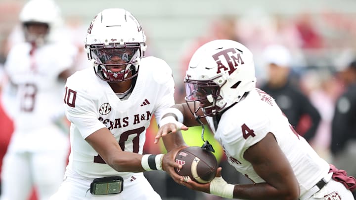 Oct 18, 2025; Fayetteville, Arkansas, USA; Texas A&M Aggies quarterback Marcel Reed (10) and running back Rueben Owens II (4) warm up prior to the game against the Arkansas Razorbacks at Donald W. Reynolds Razorback Stadium. Mandatory Credit: Nelson Chenault-Imagn Images