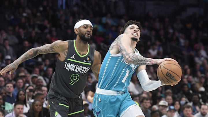 Mar 5, 2025; Charlotte, North Carolina, USA;  Charlotte Hornets guard LaMelo Ball (1) drives to the basket past Minnesota Timberwolves guard Nickel Alexander-Walker (9) during the first half at the Spectrum Center. Mandatory Credit: Sam Sharpe-Imagn Images