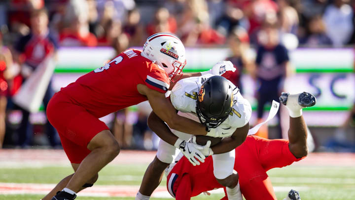 Oct 19, 2024; Tucson, Arizona, USA; Arizona Wildcats linebacker Taye Brown (6) tackles Colorado Buffalos running back Dallan Hayden (7) at Arizona Stadium. Mandatory Credit: Mark J. Rebilas-Imagn Images