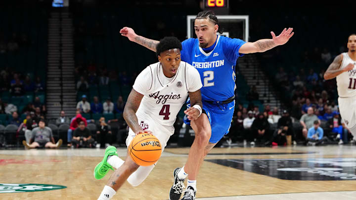 Nov 27, 2024; Las Vegas, Nevada, USA; Texas A&M Aggies guard Wade Taylor IV (4) dribbles against Creighton Bluejays guard Pop Isaacs (2) during the first half at MGM Grand Garden Arena. Mandatory Credit: Stephen R. Sylvanie-Imagn Images