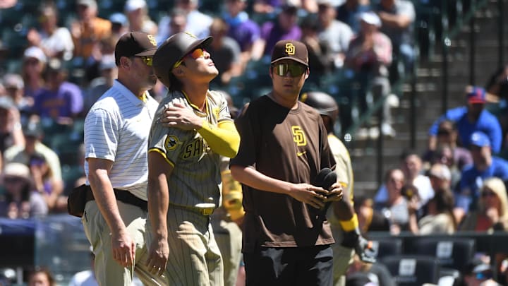Former San Diego Padres shortstop Ha-Seong Kim (7) leaves the game after an injury in the third inning against the Colorado Rockies at Coors Field. 
