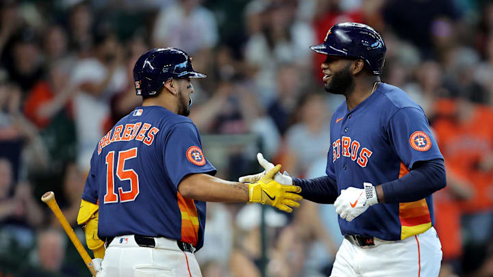 Houston Astros designated hitter Yordan Alvarez (44) is congratulated by  third baseman Isaac Paredes (15).