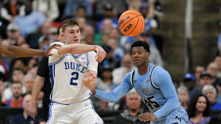 Mar 21, 2025; Raleigh, NC, USA; Duke Blue Devils forward Cooper Flagg (2) passes the ball defended by Mount St. Mary's Mountaineers guard Xavier Lipscomb (45) during the first half in the first round of the NCAA Tournament at Lenovo Center. Mandatory Credit: Zachary Taft-Imagn Images