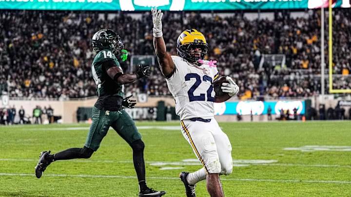 Michigan running back Justice Haynes (22) runs for a touchdown against Michigan State defensive back Malcolm Bell (14) during the second half at Spartan Stadium in East Lansing on Saturday, October 25, 2025. Michigan running back Justice Haynes (22) runs for a touchdown against Michigan State defensive back Malcolm Bell (14) during the second half at Spartan Stadium in East Lansing on Saturday, October 25, 2025.