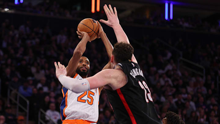 New York Knicks forward Mikal Bridges scores a basket against Portland Trail Blazers center Donovan Clingan. Mandatory Credit: Vincent Carchietta-Imagn Images