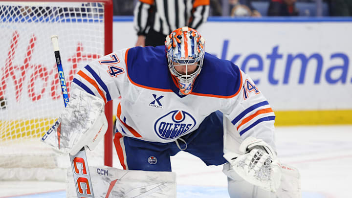 Nov 17, 2025; Buffalo, New York, USA;  Edmonton Oilers goaltender Stuart Skinner (74) looks to cover ups the puck during the second period against the Buffalo Sabres at KeyBank Center. Mandatory Credit: Timothy T. Ludwig-Imagn Images