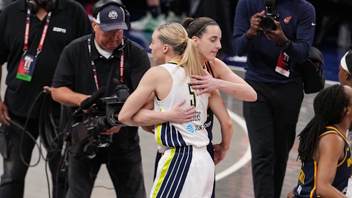 Indiana Fever guard Caitlin Clark (22) and Dallas Wings guard Paige Bueckers (5) hug Sunday, July 13, 2025, ahead of the game at Gainbridge Fieldhouse in Indianapolis.