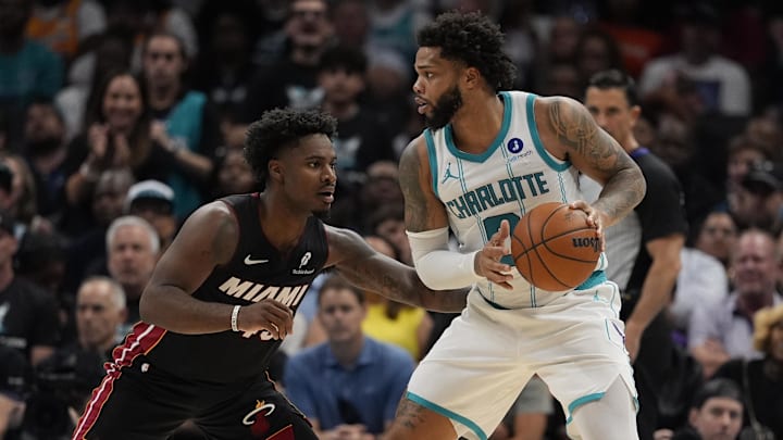 Apr 14, 2026; Charlotte, North Carolina, USA; Charlotte Hornets forward Miles Bridges (0) looks to pass guarded by Miami Heat guard Davion Mitchell (45) during the second quarter during the play-in rounds between the Charlotte Hornets and the Miami Heat of the 2026 NBA Playoffs at Spectrum Center. Mandatory Credit: Jim Dedmon-Imagn Images Apr 14, 2026; Charlotte, North Carolina, USA; Charlotte Hornets forward Miles Bridges (0) looks to pass guarded by Miami Heat guard Davion Mitchell (45) during the second quarter during the play-in rounds between the Charlotte Hornets and the Miami Heat of the 2026 NBA Playoffs at Spectrum Center. Mandatory Credit: Jim Dedmon-Imagn Images