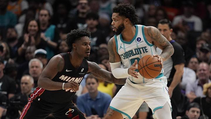 Charlotte Hornets forward Miles Bridges (0) looks to pass guarded by Miami Heat guard Davion Mitchell Charlotte Hornets forward Miles Bridges (0) looks to pass guarded by Miami Heat guard Davion Mitchell
