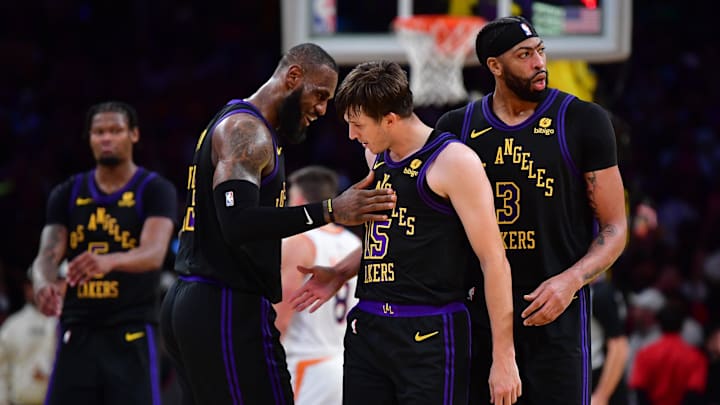 Dec 5, 2023; Los Angeles, California, USA; Los Angeles Lakers guard Austin Reaves (15) reacts after scoring three point basket against the Phoenix Suns with forward LeBron James (23) and forward Anthony Davis (3) during the second half of the In Season Tournament quarterfinal at Crypto.com Arena. Mandatory Credit: Gary A. Vasquez-Imagn Images