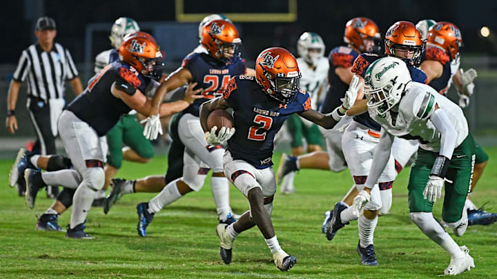 Lemon Bay's Taron Sanders (2) stiff arms. Lakewood Ranch Mustangs comes up short 13-20 as the Lemon Bay Manta Rays went on to win Thursday evening, August 24, 2023, at their Veterans stadium in Englewood, Florida.