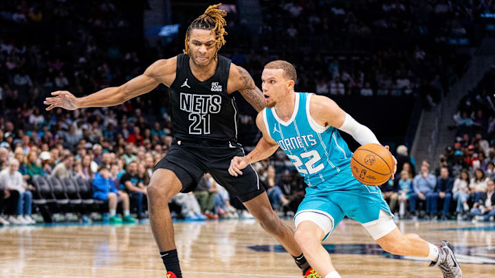 Mar 8, 2025; Charlotte, North Carolina, USA; Charlotte Hornets guard Malachi Flynn (22) drives on Brooklyn Nets forward Noah Clowney (21) during the fourth quarter at Spectrum Center. Mandatory Credit: Scott Kinser-Imagn Images