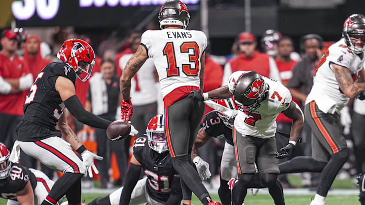 Oct 3, 2024; Atlanta, Georgia, USA; Atlanta Falcons safety Jessie Bates III (3) causes Tampa Bay Buccaneers running back Bucky Irving (7) to fumble recovered by the Falcons during the second half at Mercedes-Benz Stadium. Mandatory Credit: Dale Zanine-Imagn Images