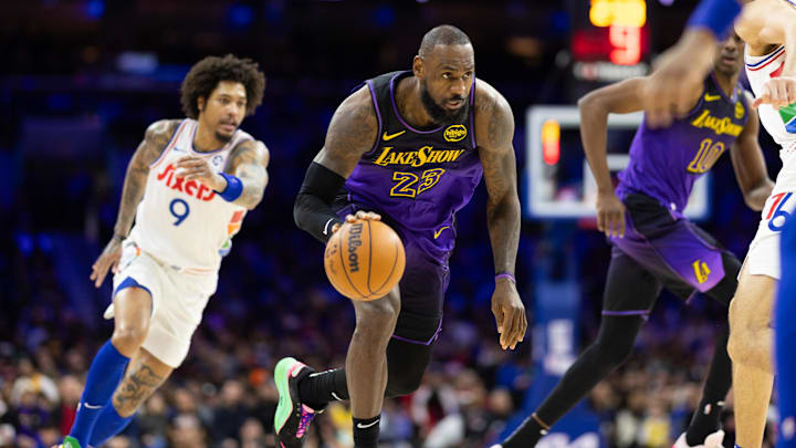 Jan 28, 2025; Philadelphia, Pennsylvania, USA; Los Angeles Lakers forward LeBron James (23) dribbles the ball in front of Philadelphia 76ers guard Kelly Oubre Jr. (9) during the second quarter at Wells Fargo Center. Mandatory Credit: Bill Streicher-Imagn Images