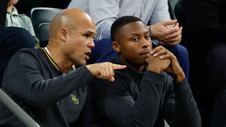 Jan 7, 2026; Waco, Texas, USA; DJ Lagway, a Florida quarterback currently in the transfer portal, sits with Baylor Bears football head coach Dave Aranda, left, during the first half of a game between the Baylor Bears and Iowa State Cyclones at Paul and Alejandra Foster Pavilion. Mandatory Credit: Chris Jones-Imagn Images Jan 7, 2026; Waco, Texas, USA; DJ Lagway, a Florida quarterback currently in the transfer portal, sits with Baylor Bears football head coach Dave Aranda, left, during the first half of a game between the Baylor Bears and Iowa State Cyclones at Paul and Alejandra Foster Pavilion. Mandatory Credit: Chris Jones-Imagn Images
