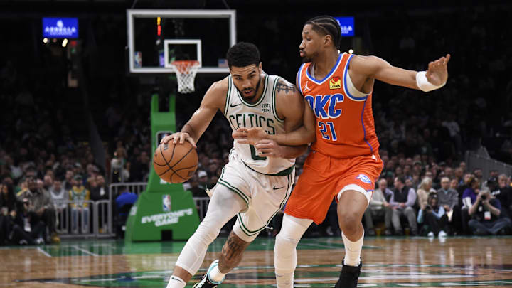 The Celtics' Jayson Tatum drives on the Thunder's Aaron Wiggins in April 2024.