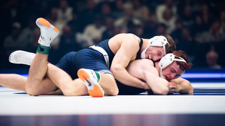 Penn State’s Mitchell Mesebrink, top, wrestles Iowa's Michael Caliendo in the 165-pound bout of their Big Ten dual match.