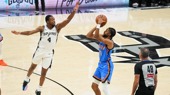May 24, 2026; San Antonio, Texas, USA; Oklahoma City Thunder guard Isaiah Joe (11) shoots while defended by San Antonio Spurs guard De'Aaron Fox (4) in the first half during game four of the western conference finals for the 2026 NBA playoffs at Frost Bank Center. Mandatory Credit: Scott Wachter-Imagn Images