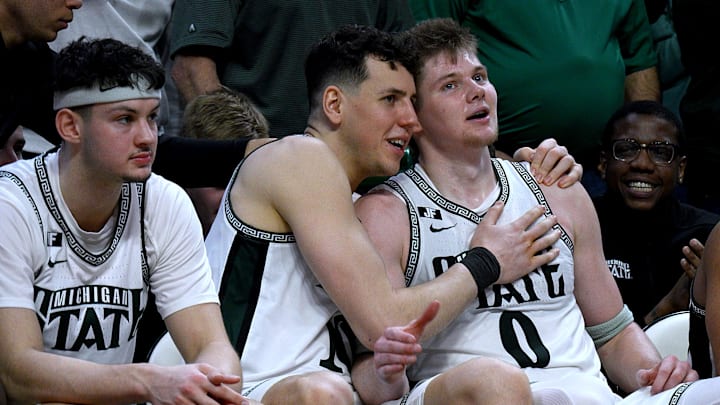 Mar 2, 2025; East Lansing, Michigan, USA;  Michigan State Spartans center Szymon Zapala (10) hugs forward Jaxon Kohler (0) who tallied a double-double against the Wisconsin Badgers at Jack Breslin Student Events Center. Mandatory Credit: Dale Young-Imagn Images