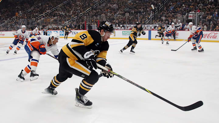 Dec 29, 2024; Pittsburgh, Pennsylvania, USA;  Pittsburgh Penguins left wing Michael Bunting (8) skates into the New York Islanders zone with the puck during the first period at PPG Paints Arena. Mandatory Credit: Charles LeClaire-Imagn Images