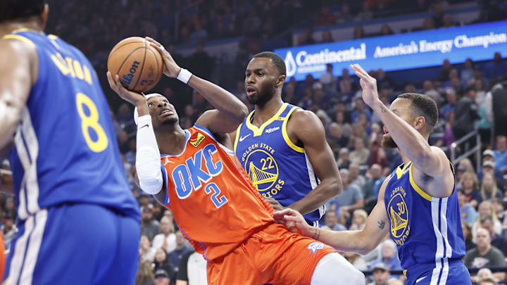 Oklahoma City Thunder guard Shai Gilgeous-Alexander (2) shoots beside Golden State Warriors forward Andrew Wiggins (22) during the first quarter at Paycom Center. Mandatory Credit: Alonzo Adams-Imagn Images